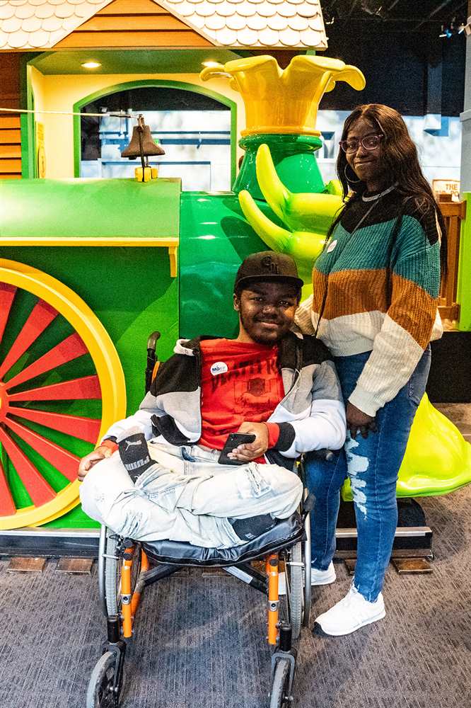 Family posing in front of train at Children's Museum
