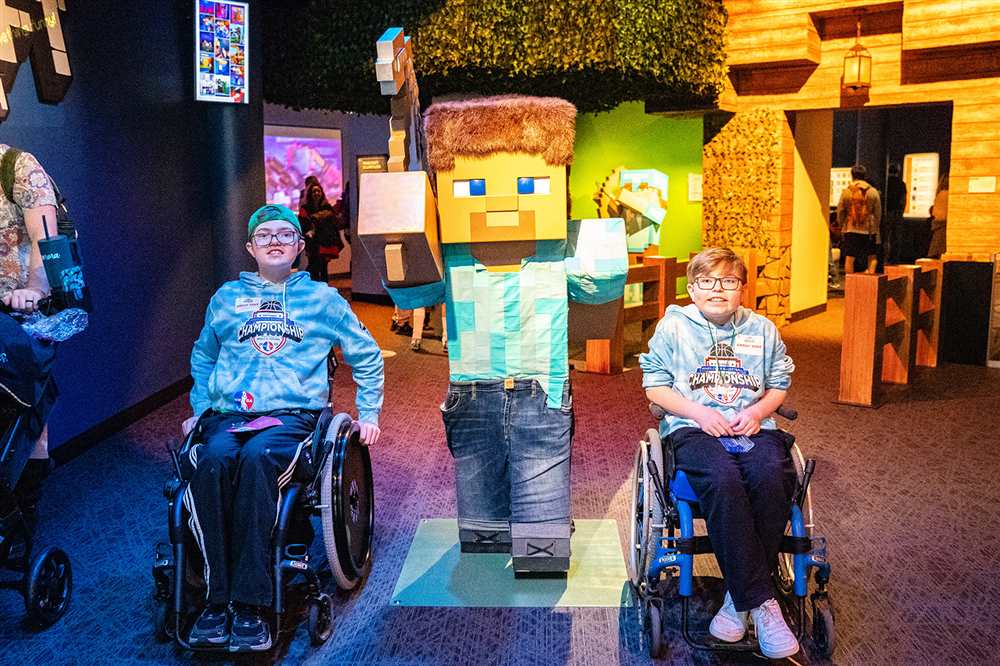 Children in wheelchairs posing with Minecraft statue